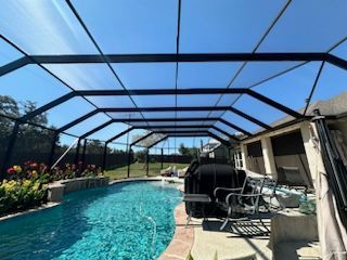 Screened pool area with outdoor seating and ceiling fan in Georgetown TX