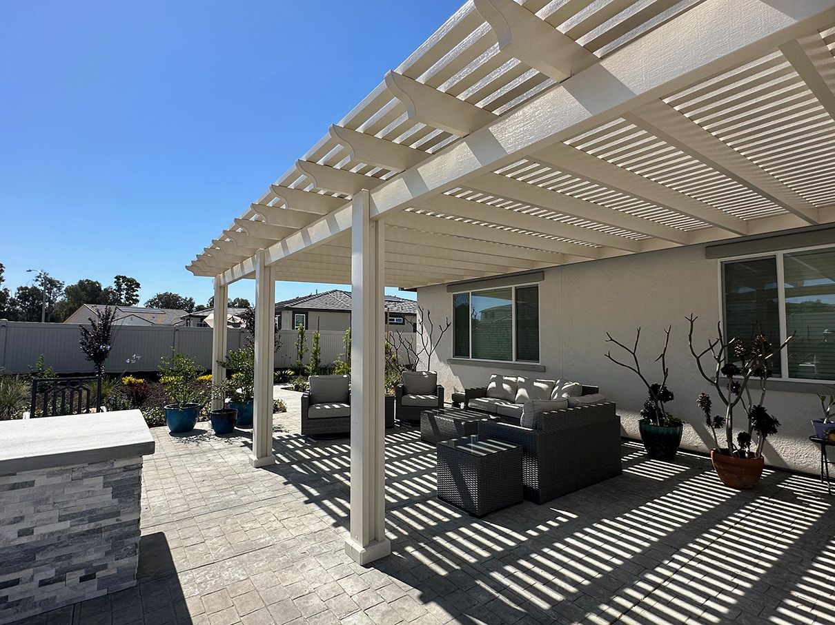 Elegant aluminum pergola in Helotes backyard with lattice roof design