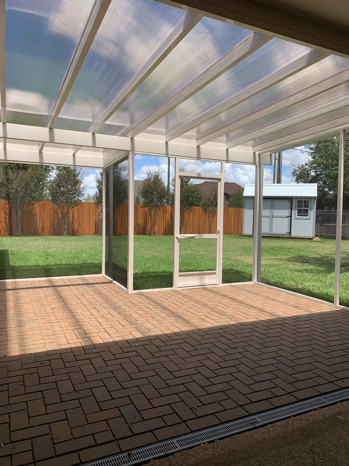 Outdoor porch area enclosed with high‑visibility screen material