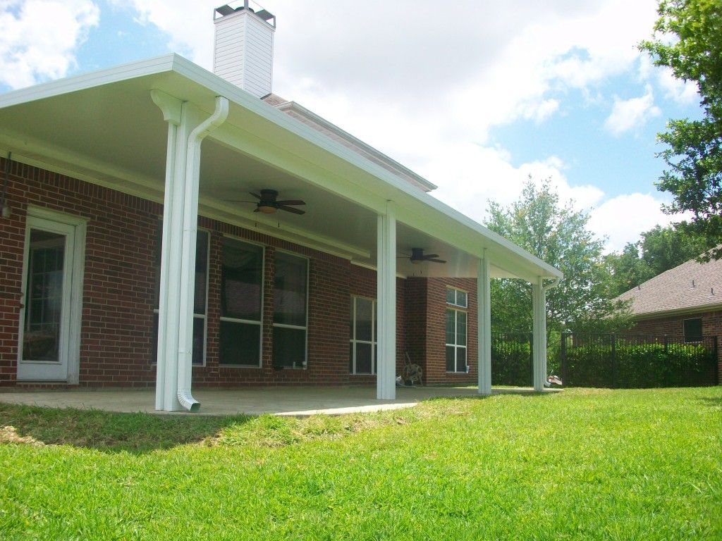 Backyard patio cover with outdoor dining setup in Kyle, TX