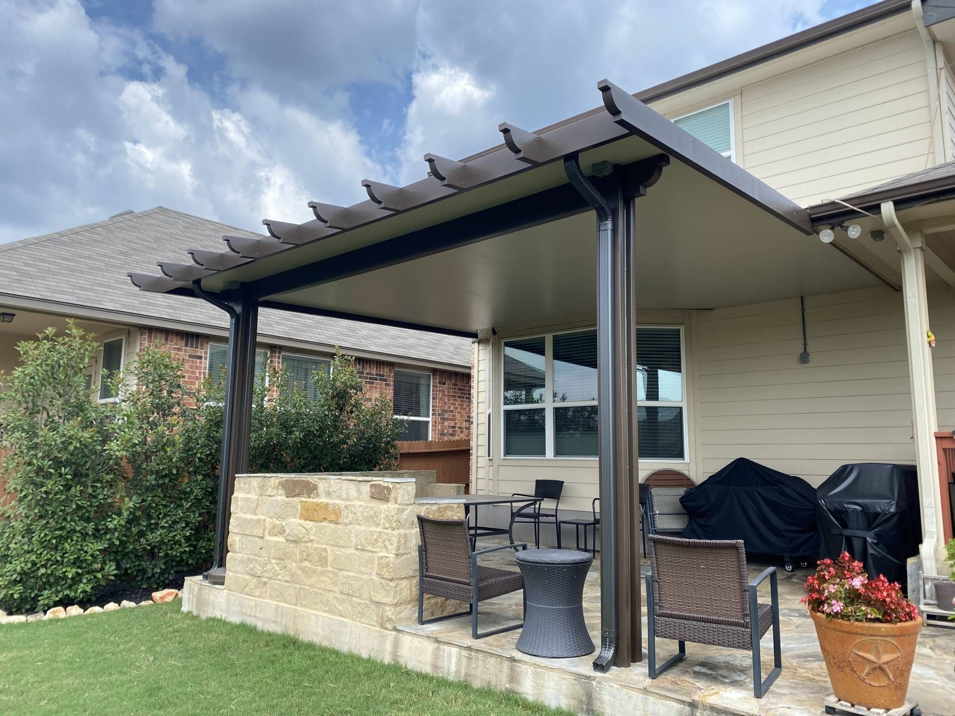 Patio cover with outdoor fireplace and seating in Buda, TX