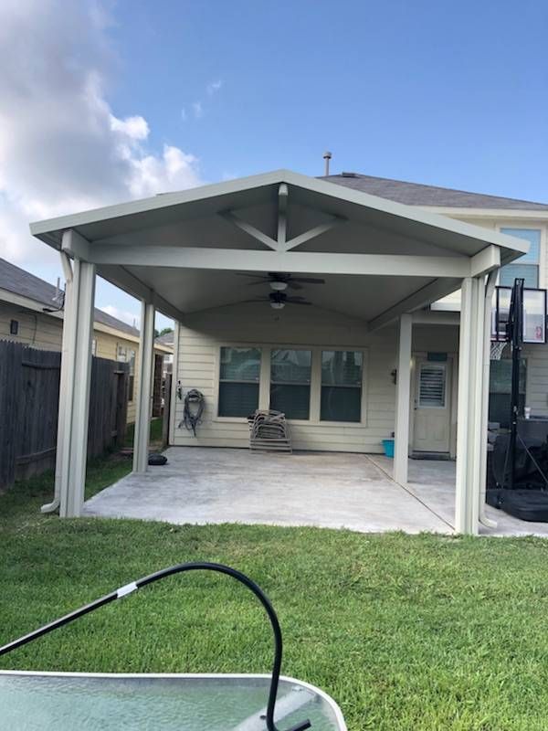 Covered patio with climbing plants and wood accents in Dripping Springs, TX