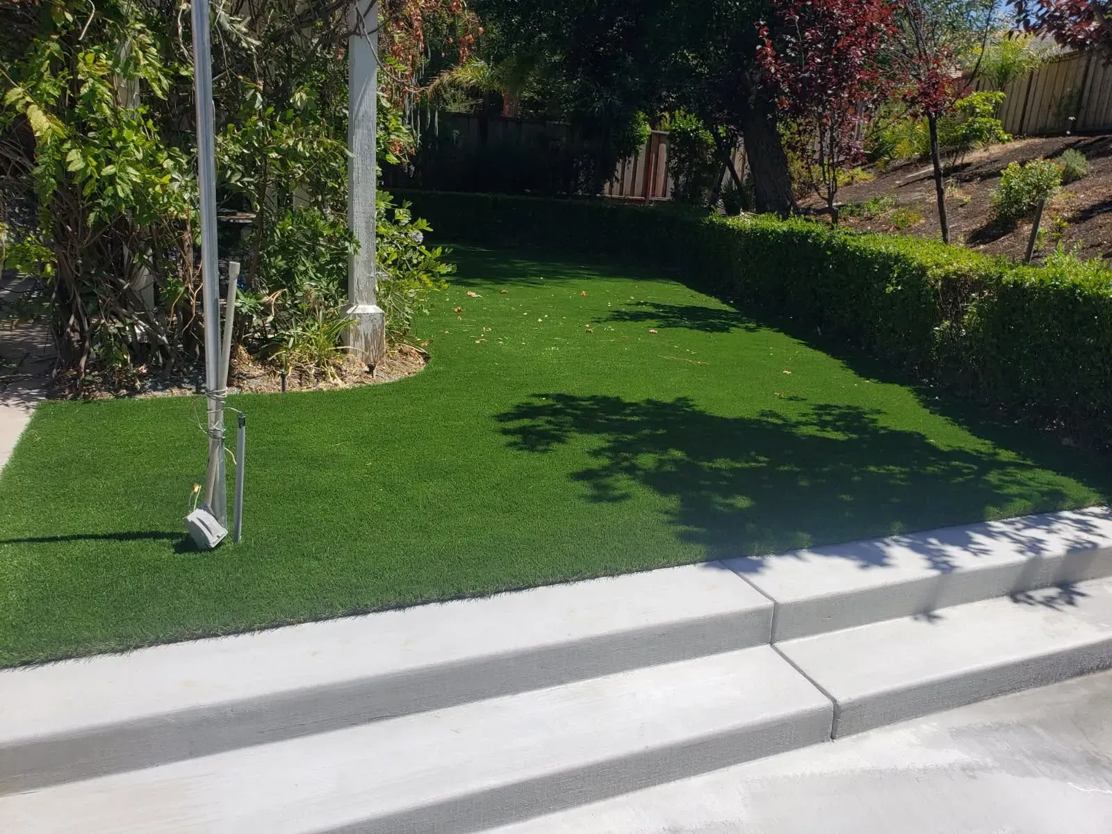A modern house with a large lawn in front of it.
