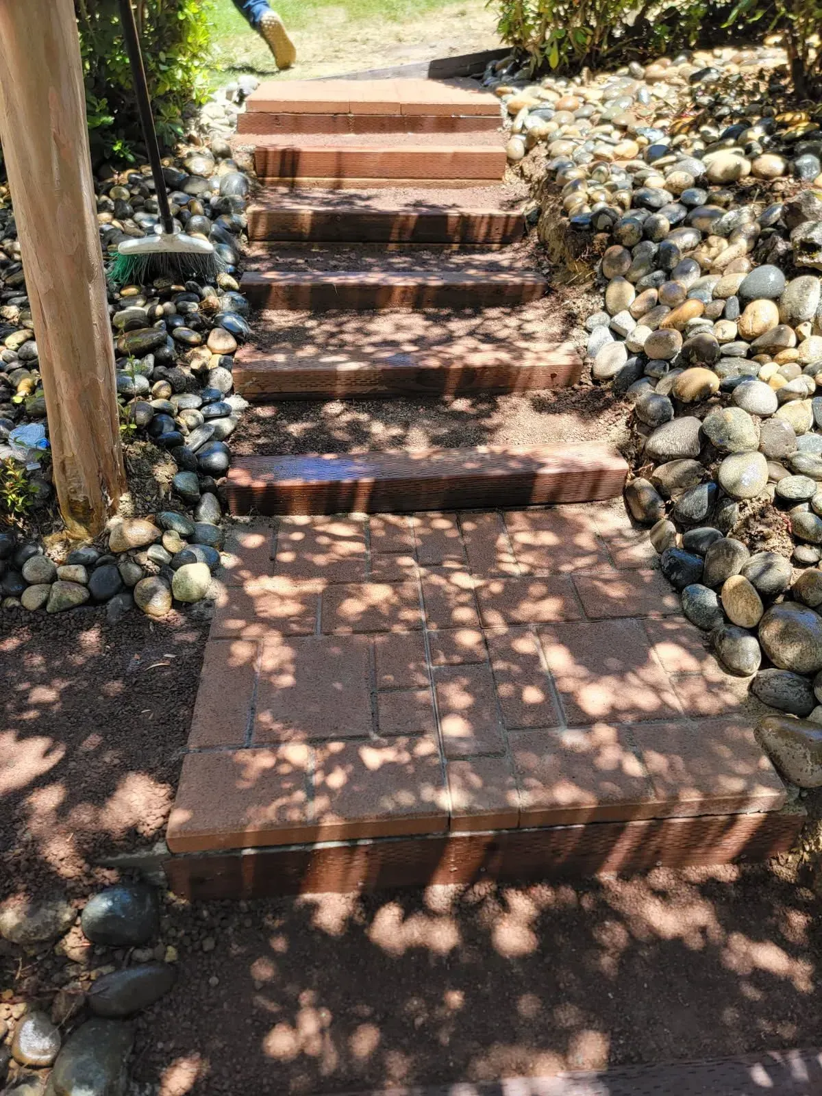 A set of brick stairs leading up to a rocky path.