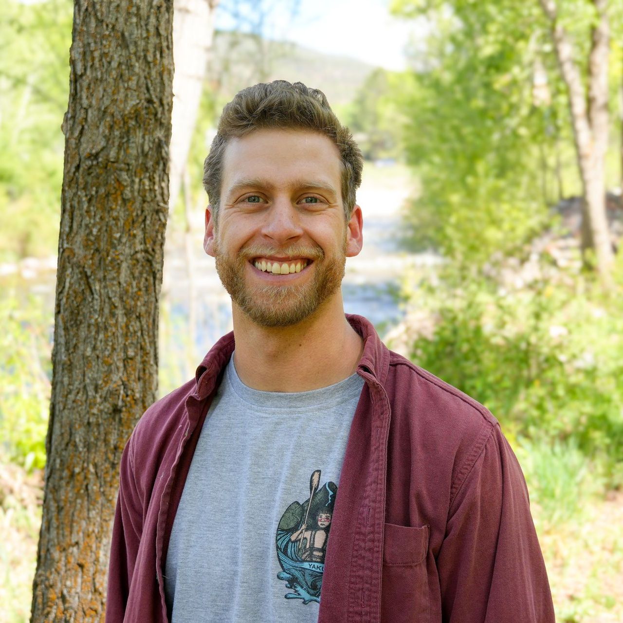 Ofek is a blonde-haired man wearing a red shirt. Ofek is a project manager with CORE.