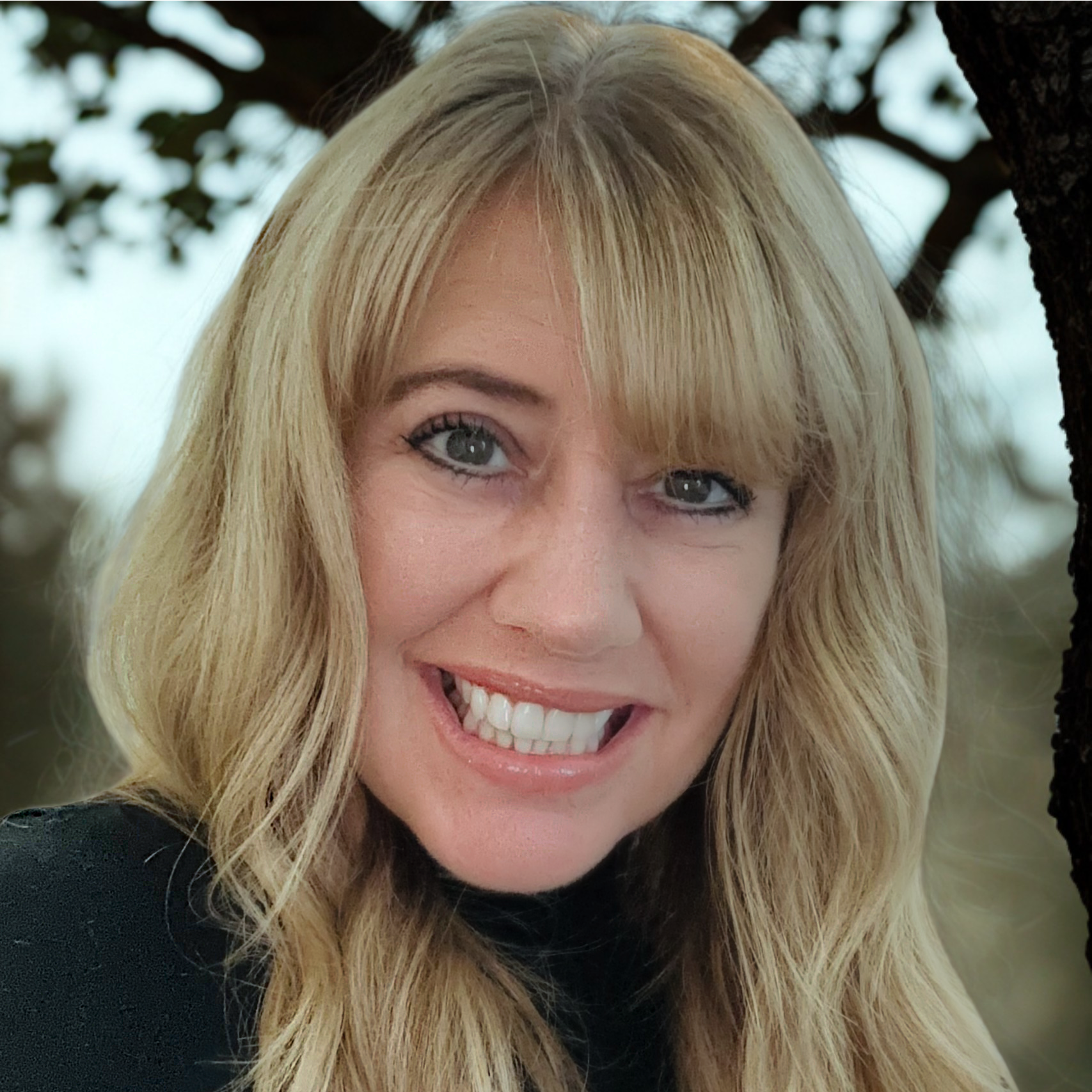 Deborah is a blonde-haired woman wearing a black shirt.