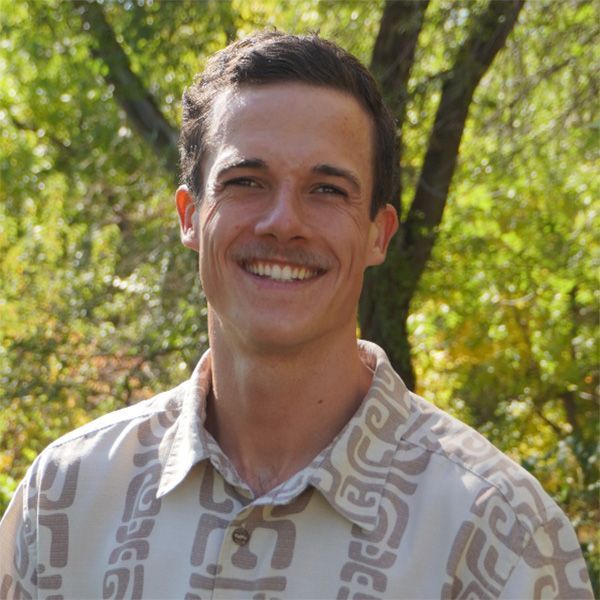 A man wearing a white and brown collared shirt