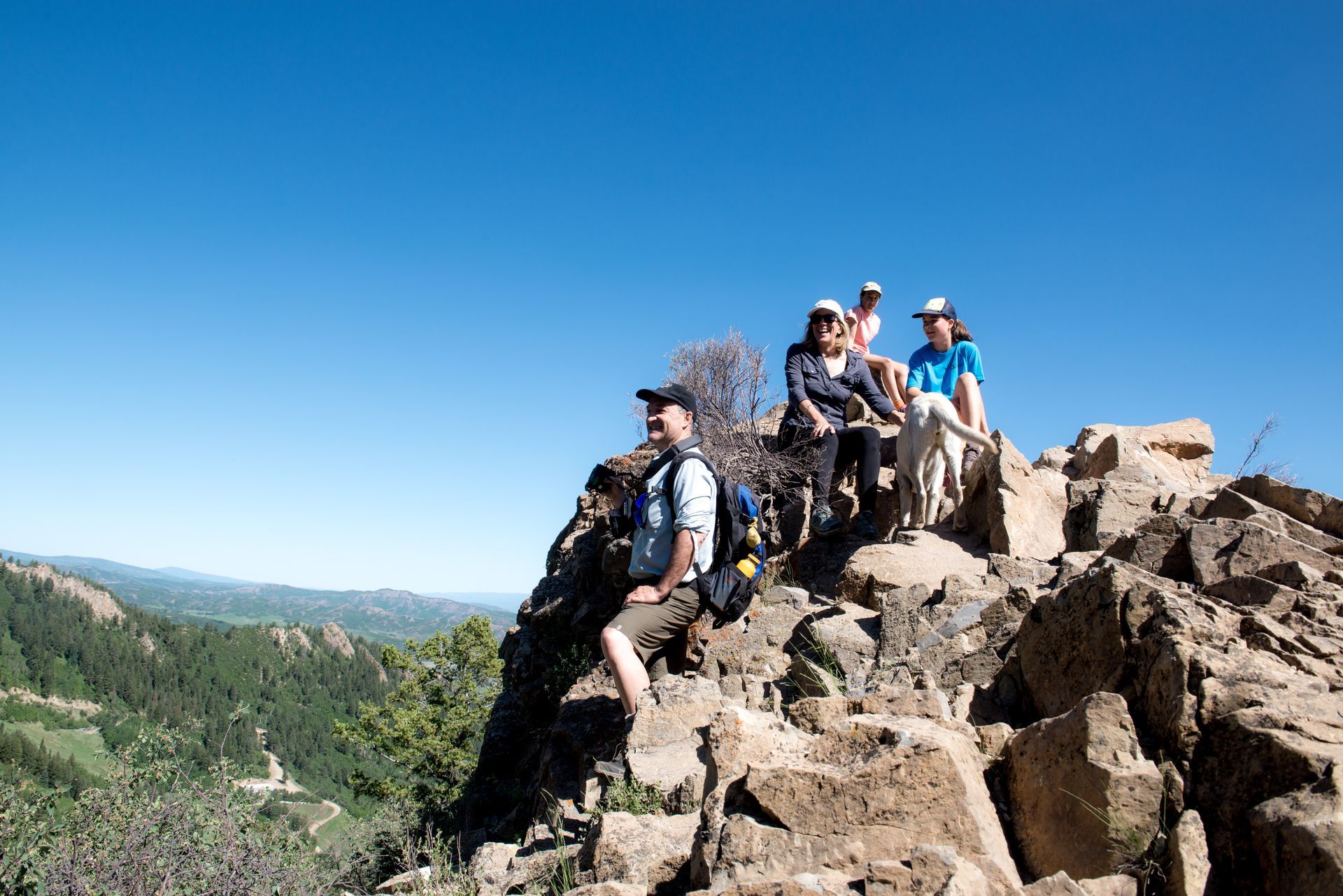 Aspen CORE workers sitting on top of a mountain