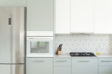 white cabinets and yellow kettle