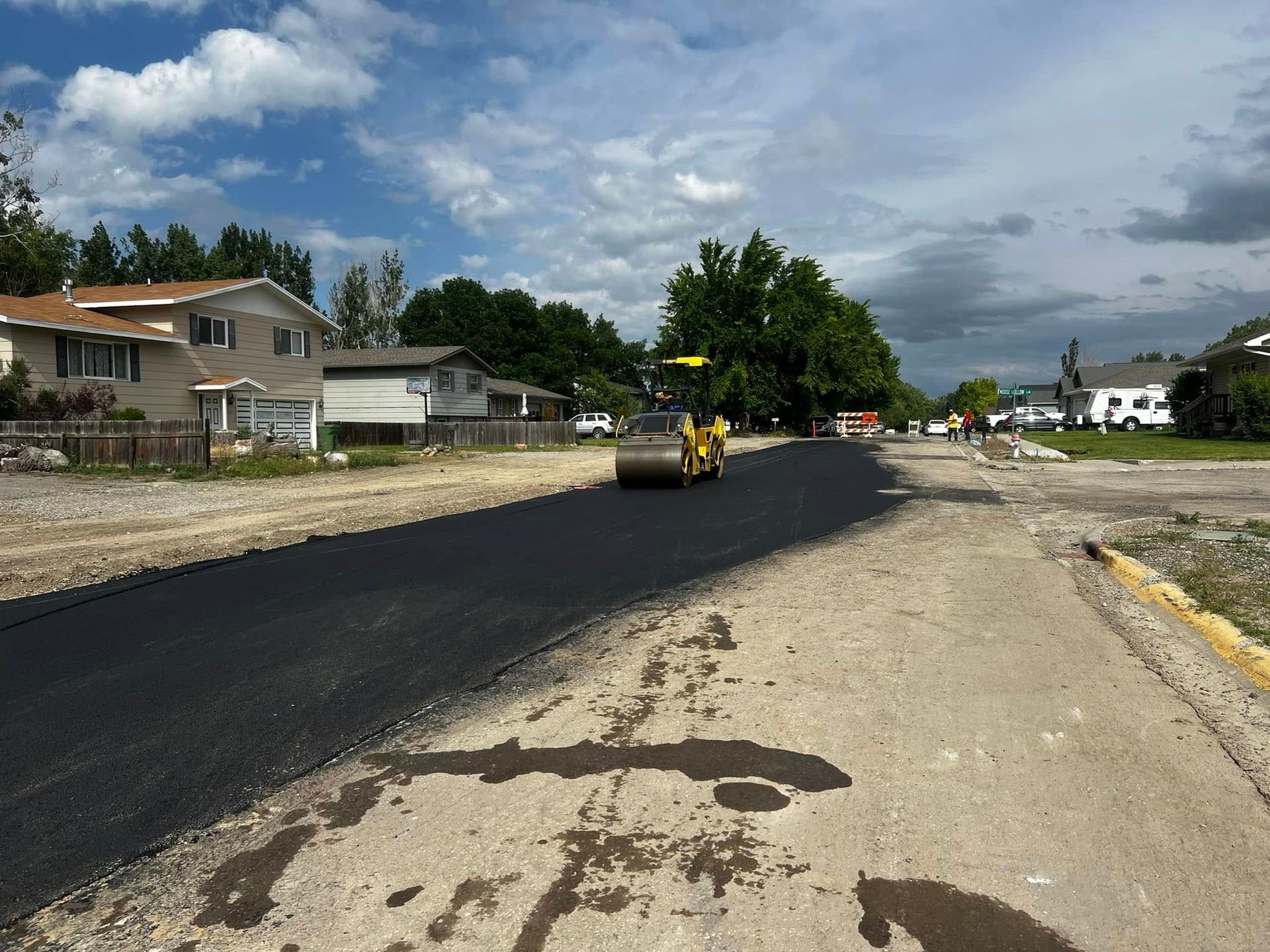 A road is being paved in a residential area.