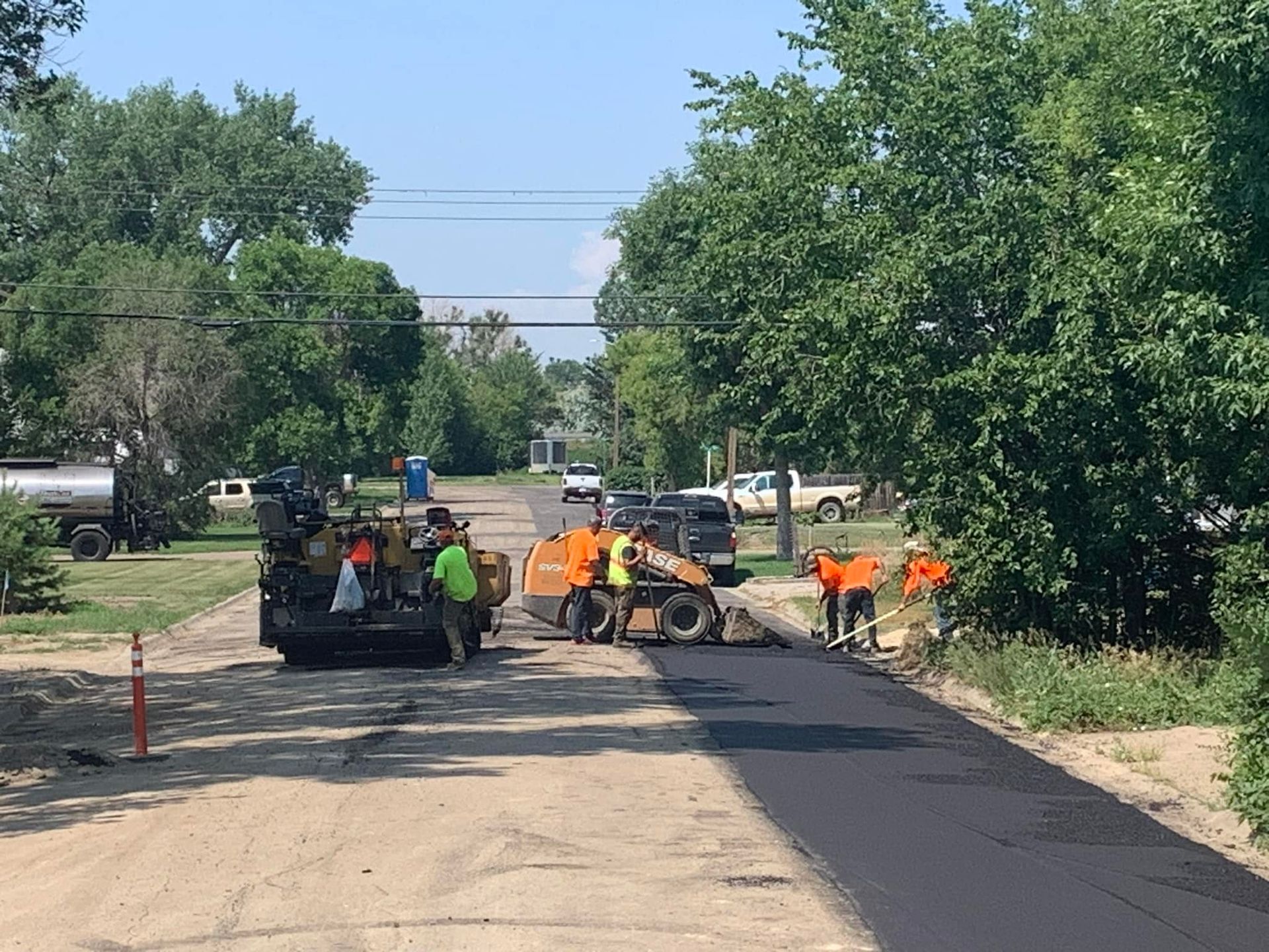 A group of people are working on a road.