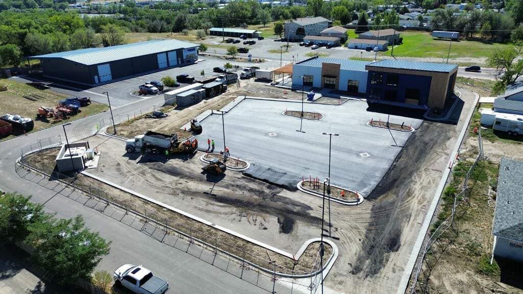 An aerial view of a building under construction in a city.