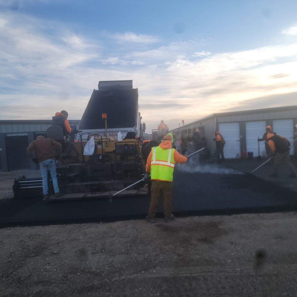 A group of construction workers are working on a road