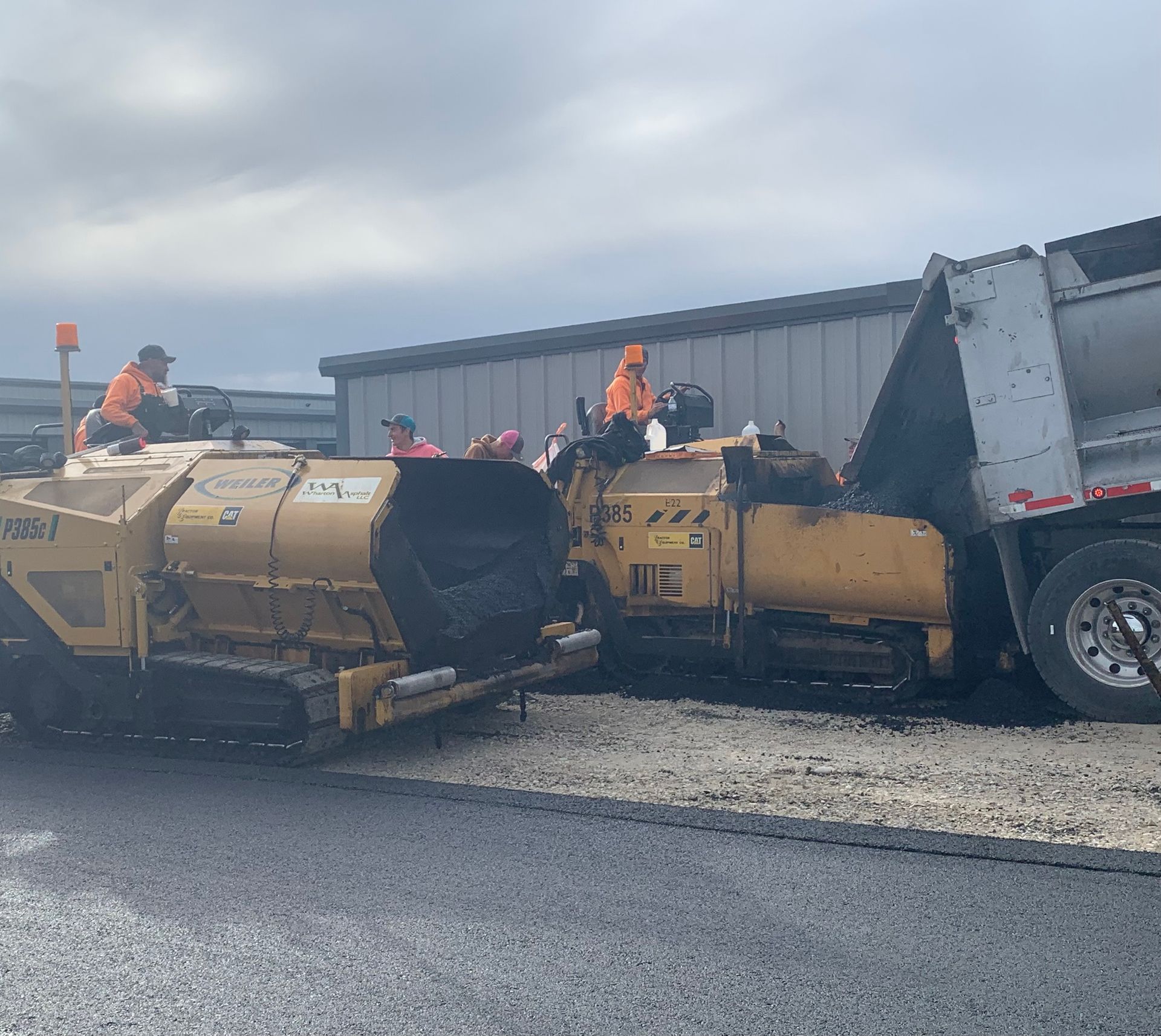 A yellow truck is parked on the side of the road