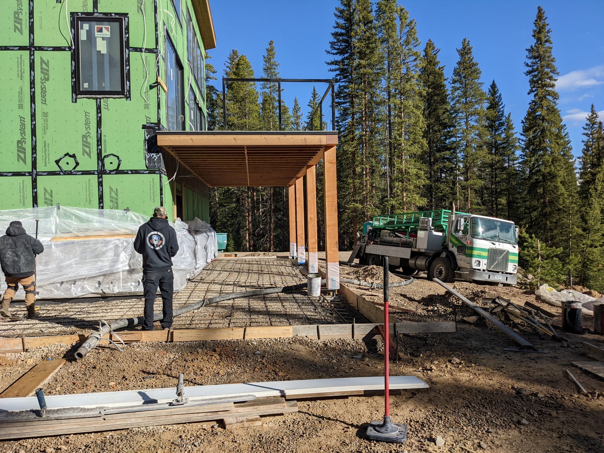 sparta green line pump truck pumping concrete into home patio