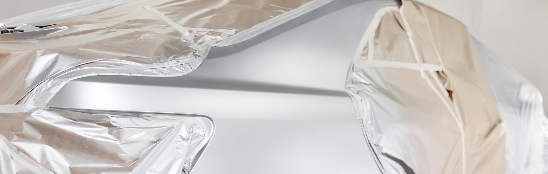 White sports car on display under spotlights at night