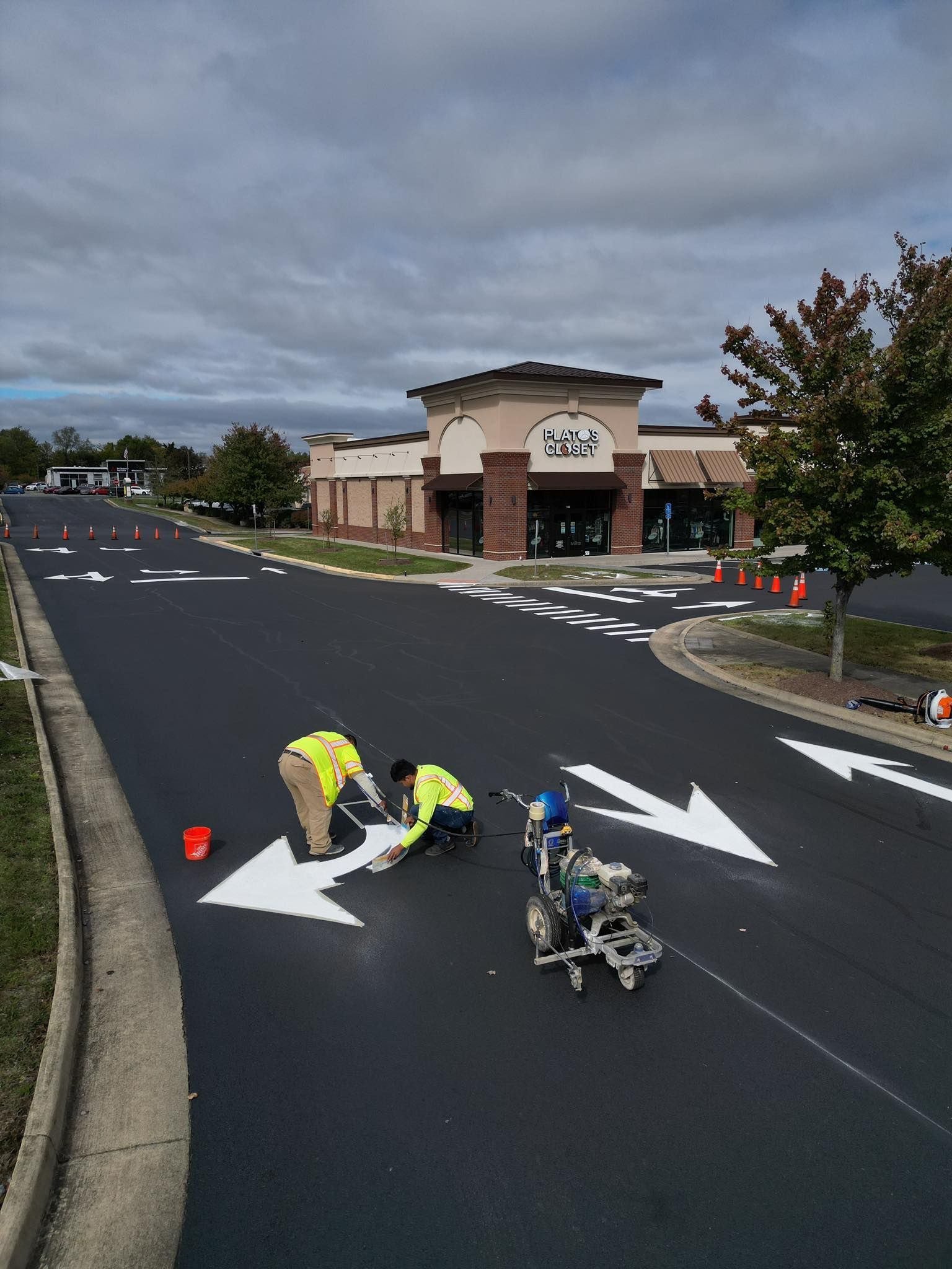 Image showing arrows for traffic painted on in a business parking area. 