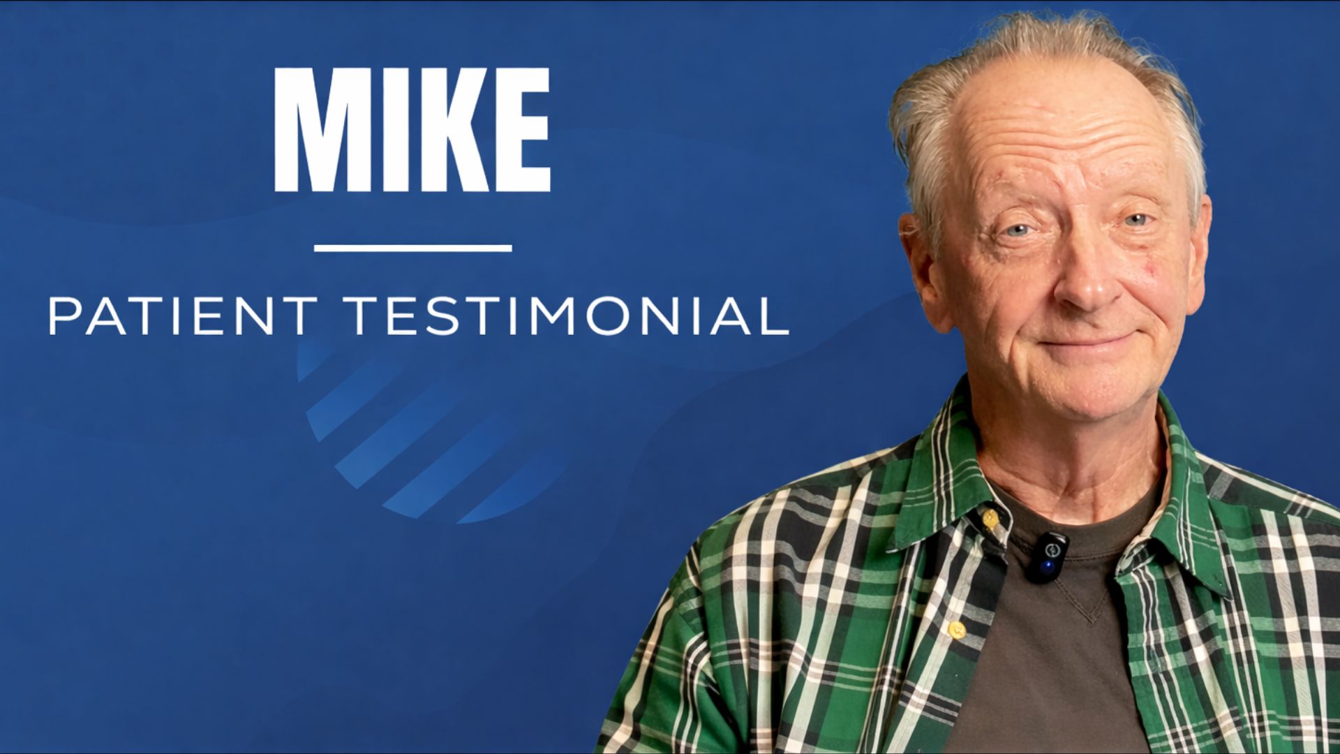 Elderly man wearing a flannel smiling. 