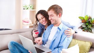 A Happy Couple Browsing on a Laptop for Retail Plant