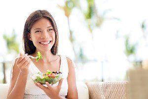 Happy Woman Eating Vegetables — Hampstead, NC —  Hampstead Medical Center PC