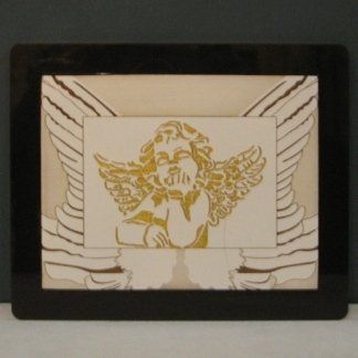 quadro con cornice nera con l'immagine di un puttino dorato su sfondo bianco