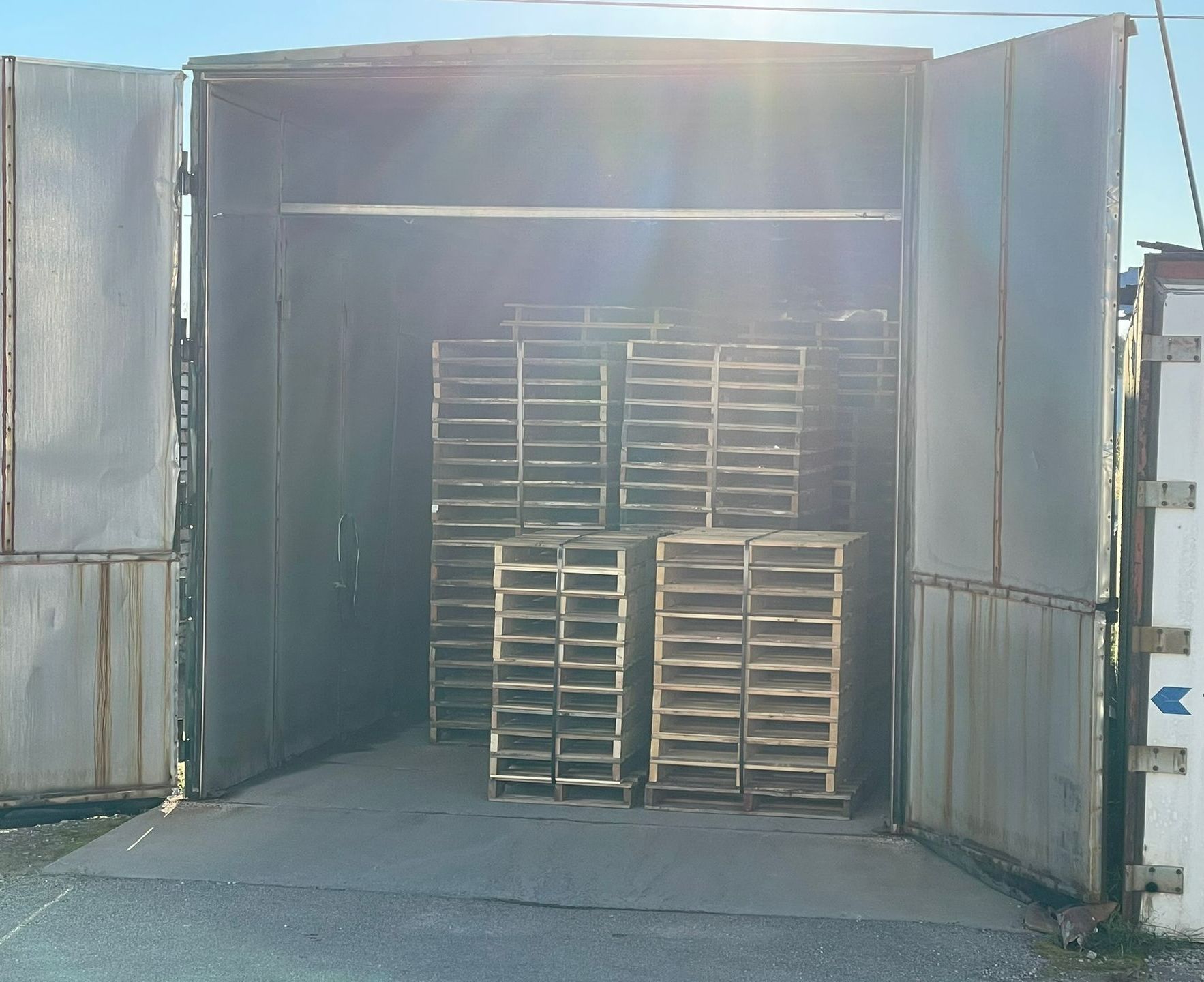 A warehouse filled with lots of wooden pallets.