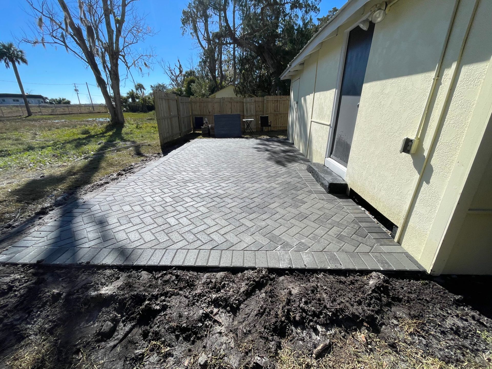A patio is being built in front of a house.