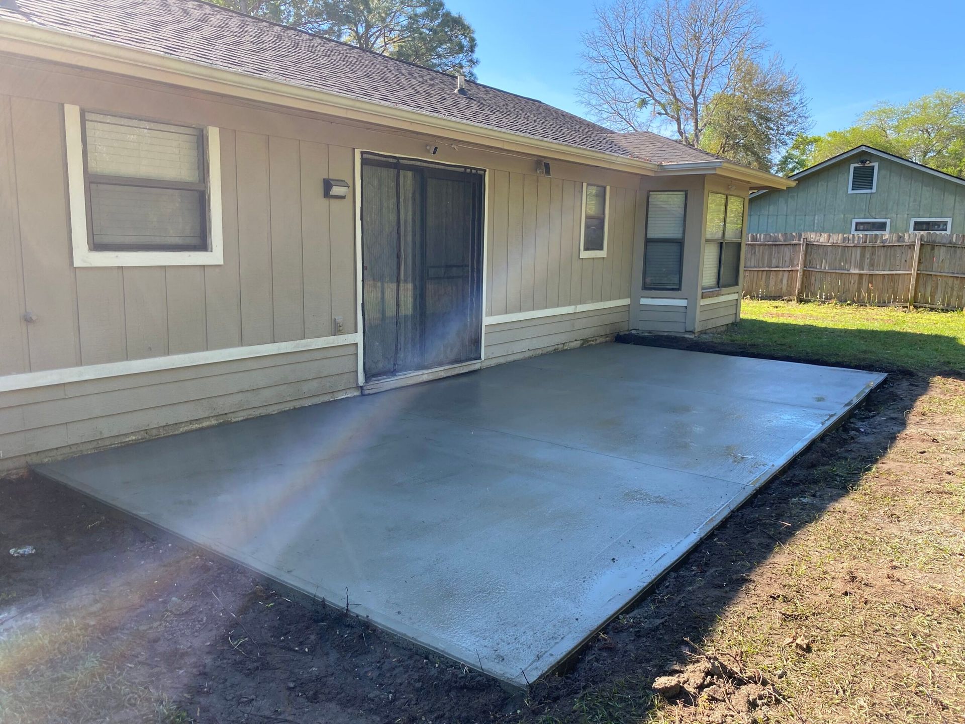 A house with a concrete patio in front of it.