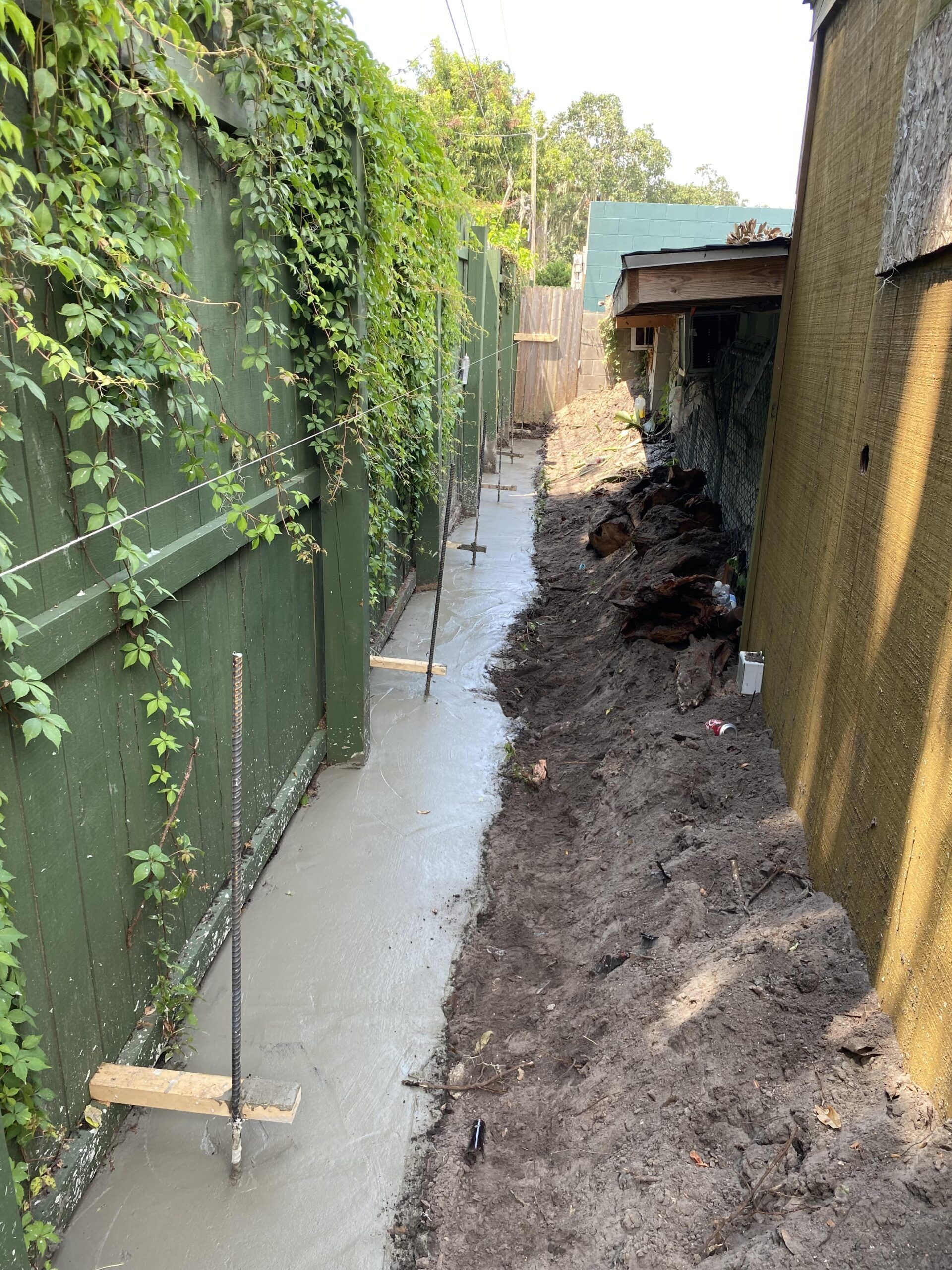 A concrete walkway is being built between two buildings.