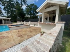 There is a swimming pool in the backyard of a house.