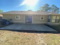 A house with a concrete patio in front of it.