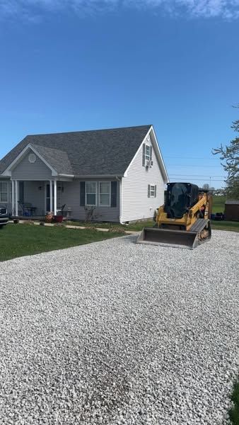 A house with a bulldozer parked in front of it.