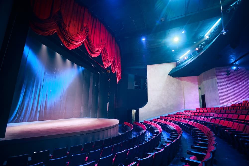 An Empty Auditorium with Rows of Red Seats and A Stage — Hantis Electrical Solutions in North Nowra, NSW