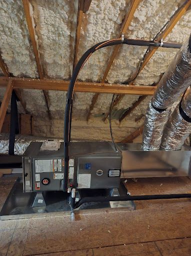 A ceiling with a box and pipes hanging from it.