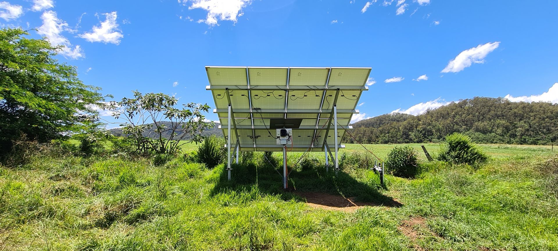 The Back View Of Solar Panels Sitting on Top of a Hill— Midcoast Irrigation & Horticultural Supplies In Wauchope, NSW