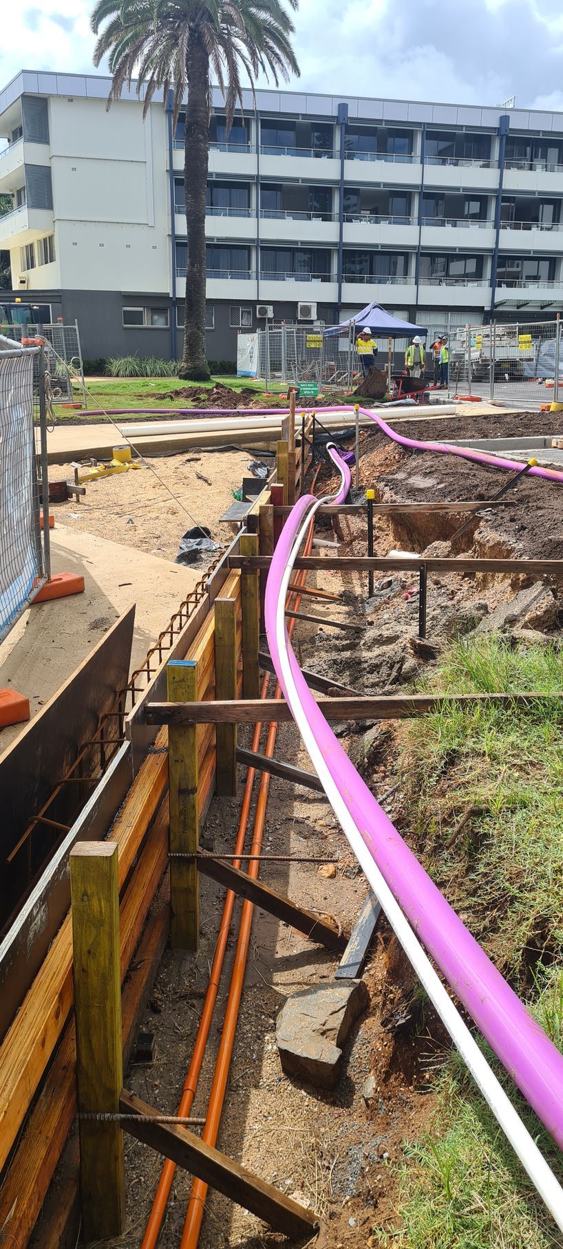 A Pink Pipe is Being Installed in a Construction Site — Midcoast Irrigation & Horticultural Supplies In Wauchope, NSW
