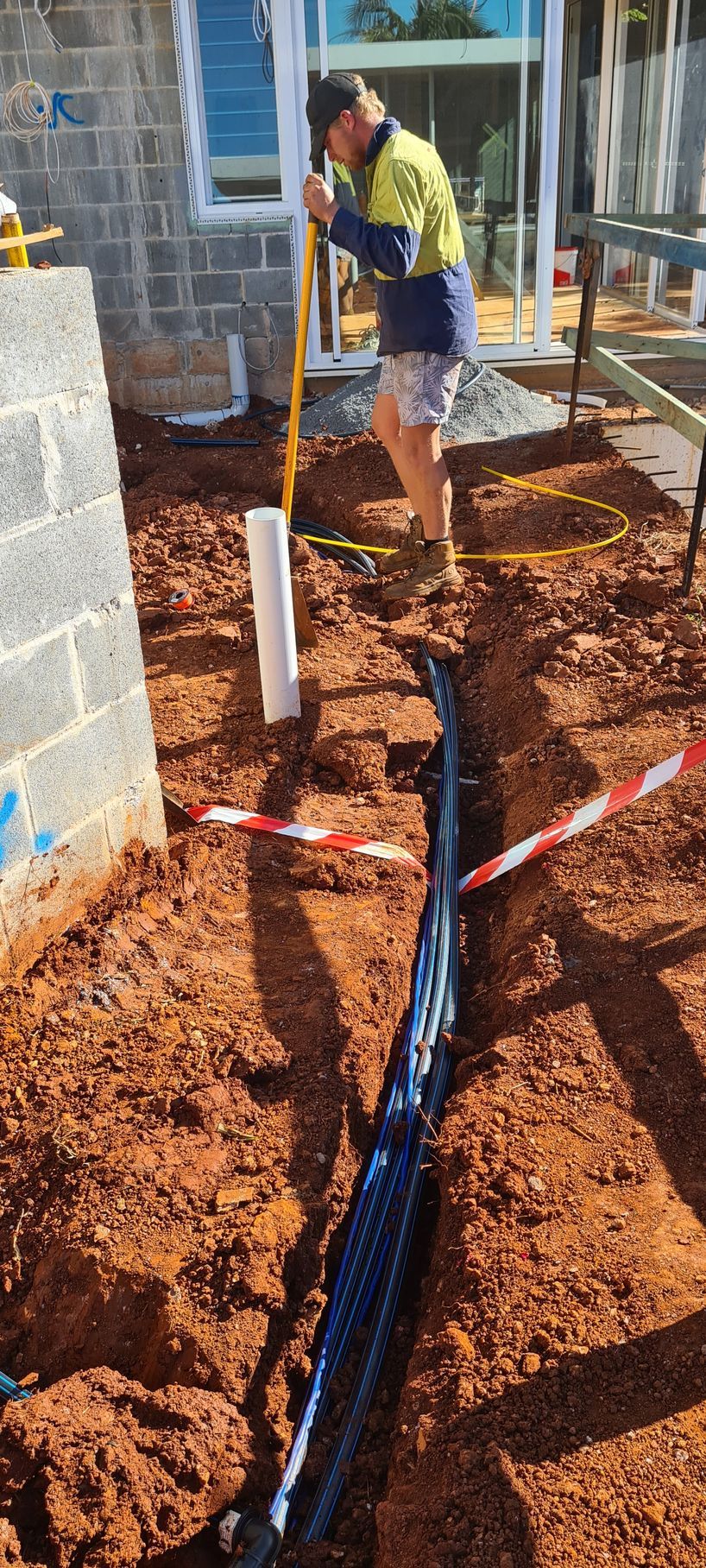 A man is digging a hole in the ground with a shovel. — Midcoast Irrigation & Horticultural Supplies In Wauchope, NSW