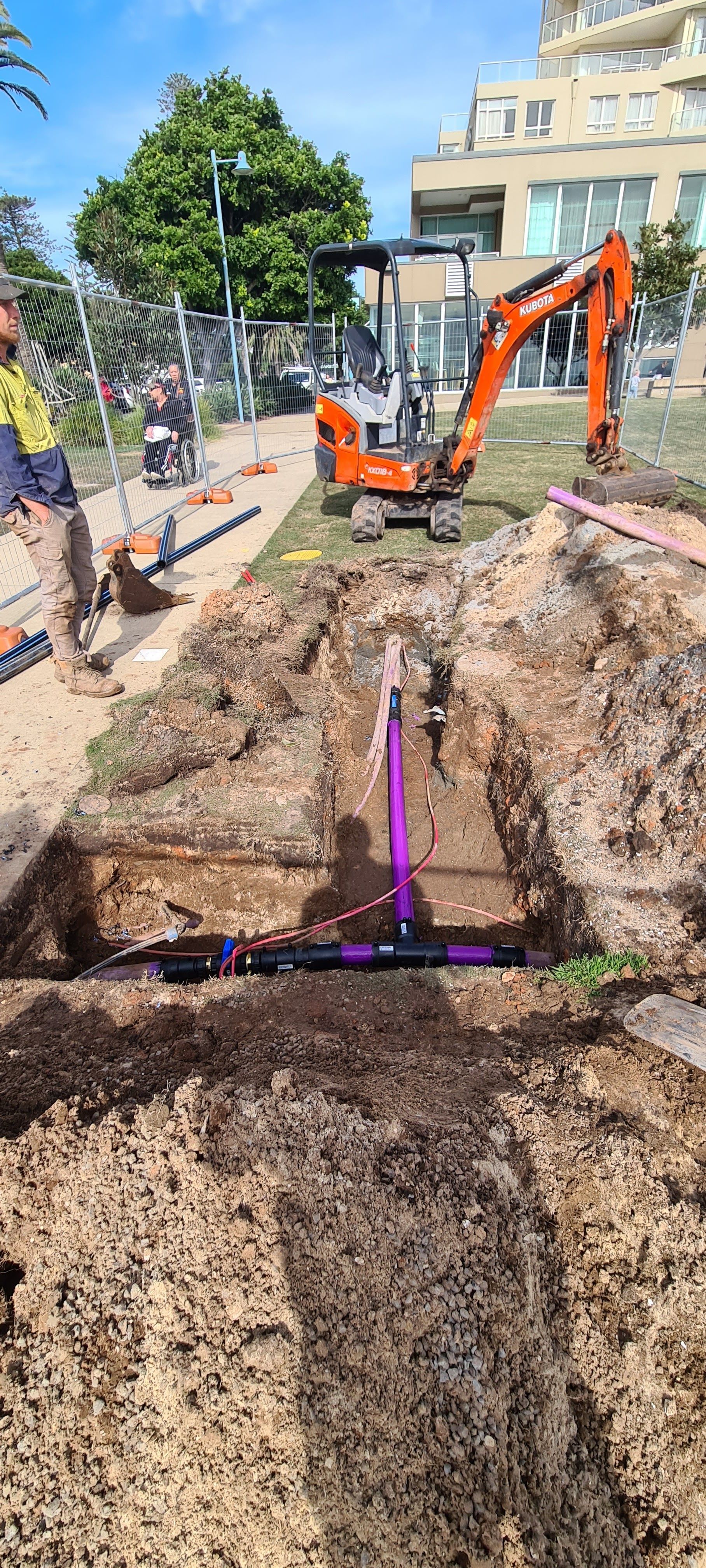 A Pink Pipe Bing Installed In A Hole On The Ground On A Construction Site — Midcoast Irrigation & Horticultural Supplies In Wauchope, NSW