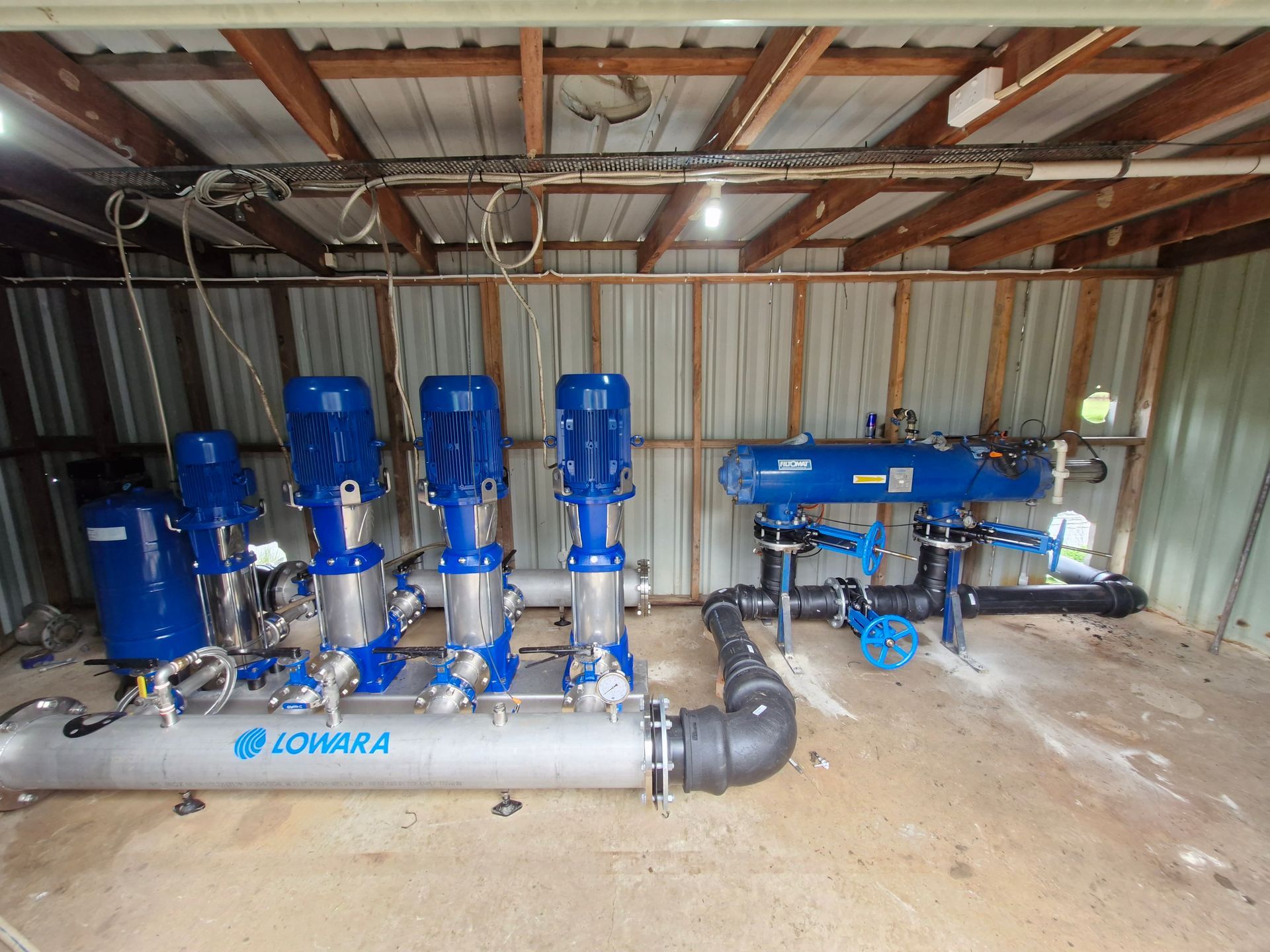 A Roll Of Industrial Pipes And  Pumps In An Irrigation System — Midcoast Irrigation & Horticultural Supplies In Wauchope, NSW