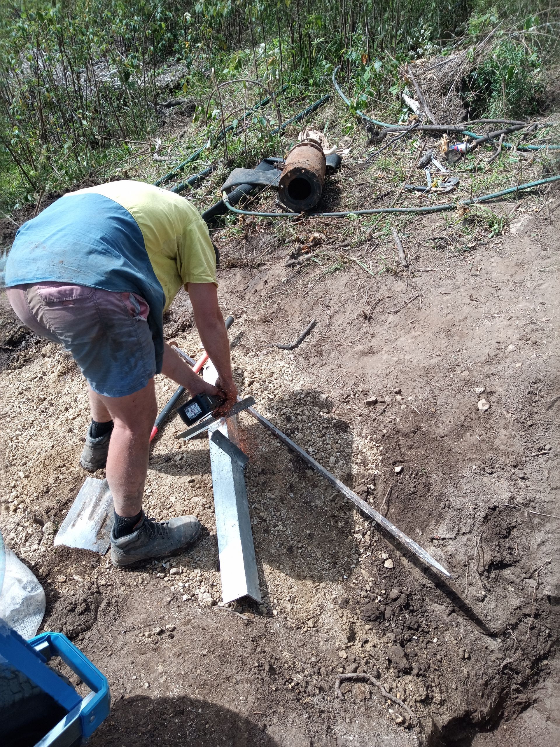 A man is digging in the dirt with a shovel.— Midcoast Irrigation & Horticultural Supplies In Wauchope, NSW
