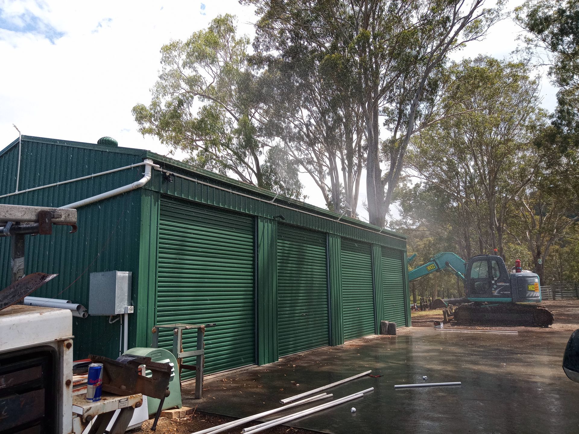 A green building with a lot of trees in the background.— Midcoast Irrigation & Horticultural Supplies In Wauchope, NSW