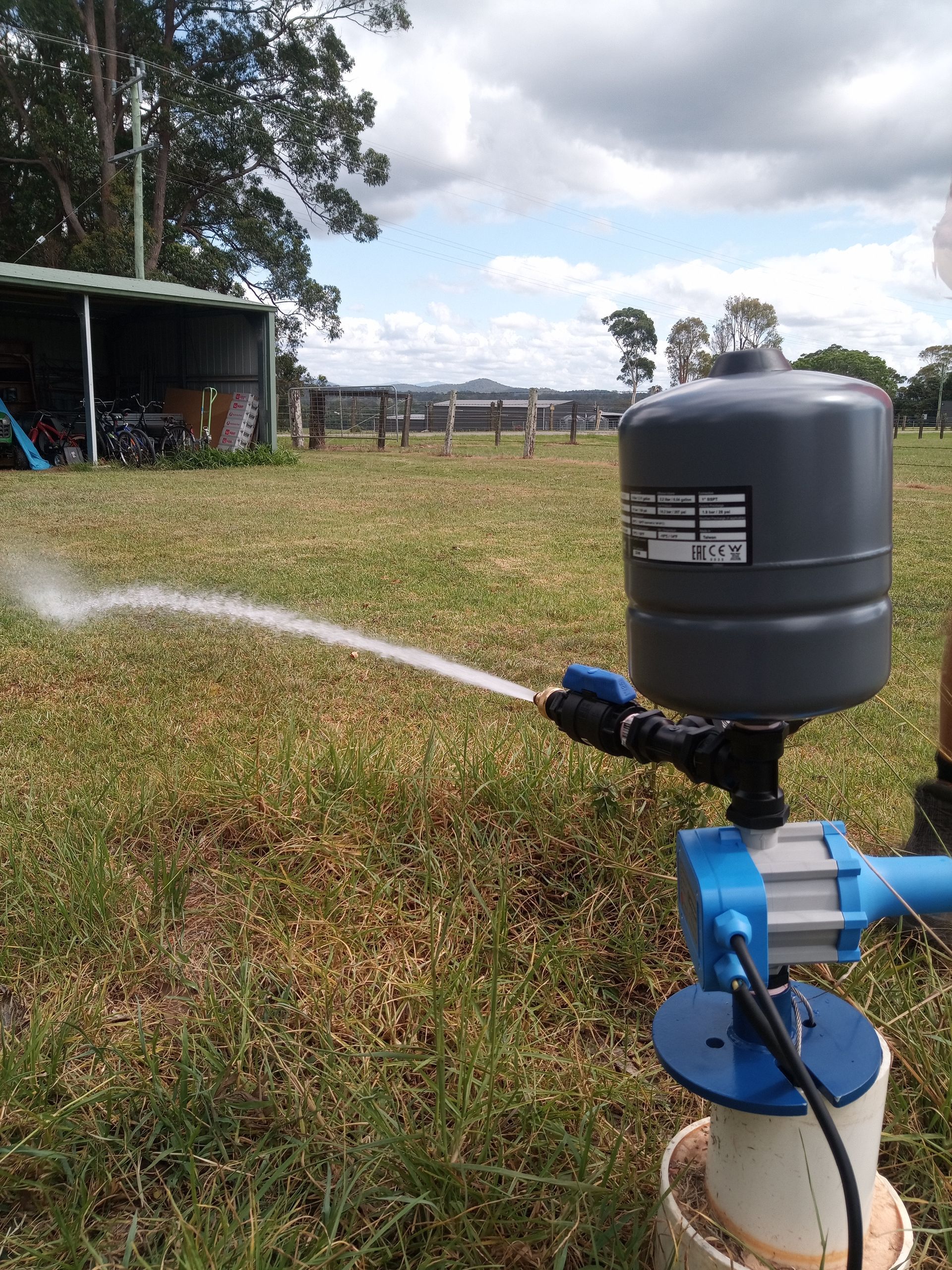 A Sprinkler is Spraying Water on a Lush Green Lawn — Midcoast Irrigation & Horticultural Supplies In Wauchope, NSW