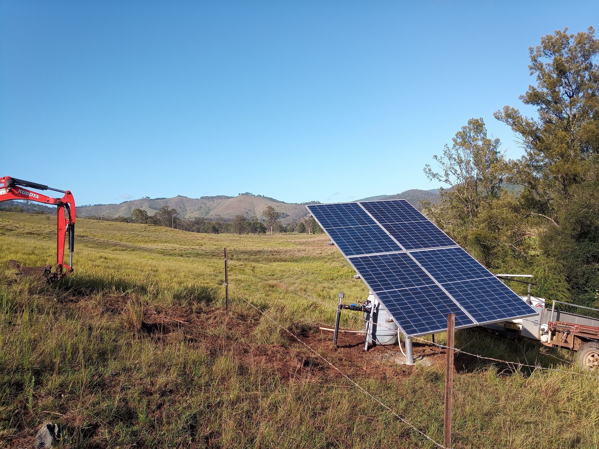 A Row of Solar Panels Sitting on Top of a Grassy Field — Midcoast Irrigation & Horticultural Supplies In Wauchope, NSW