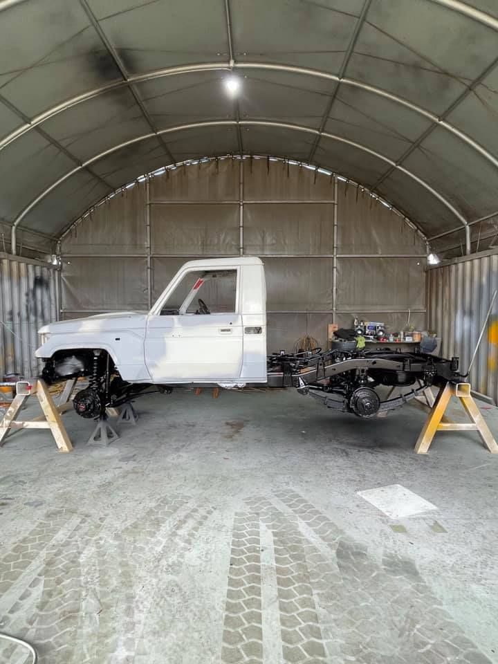 A White Truck is Being Painted in a Garage — All Blast and Paint in Sarina, QLD