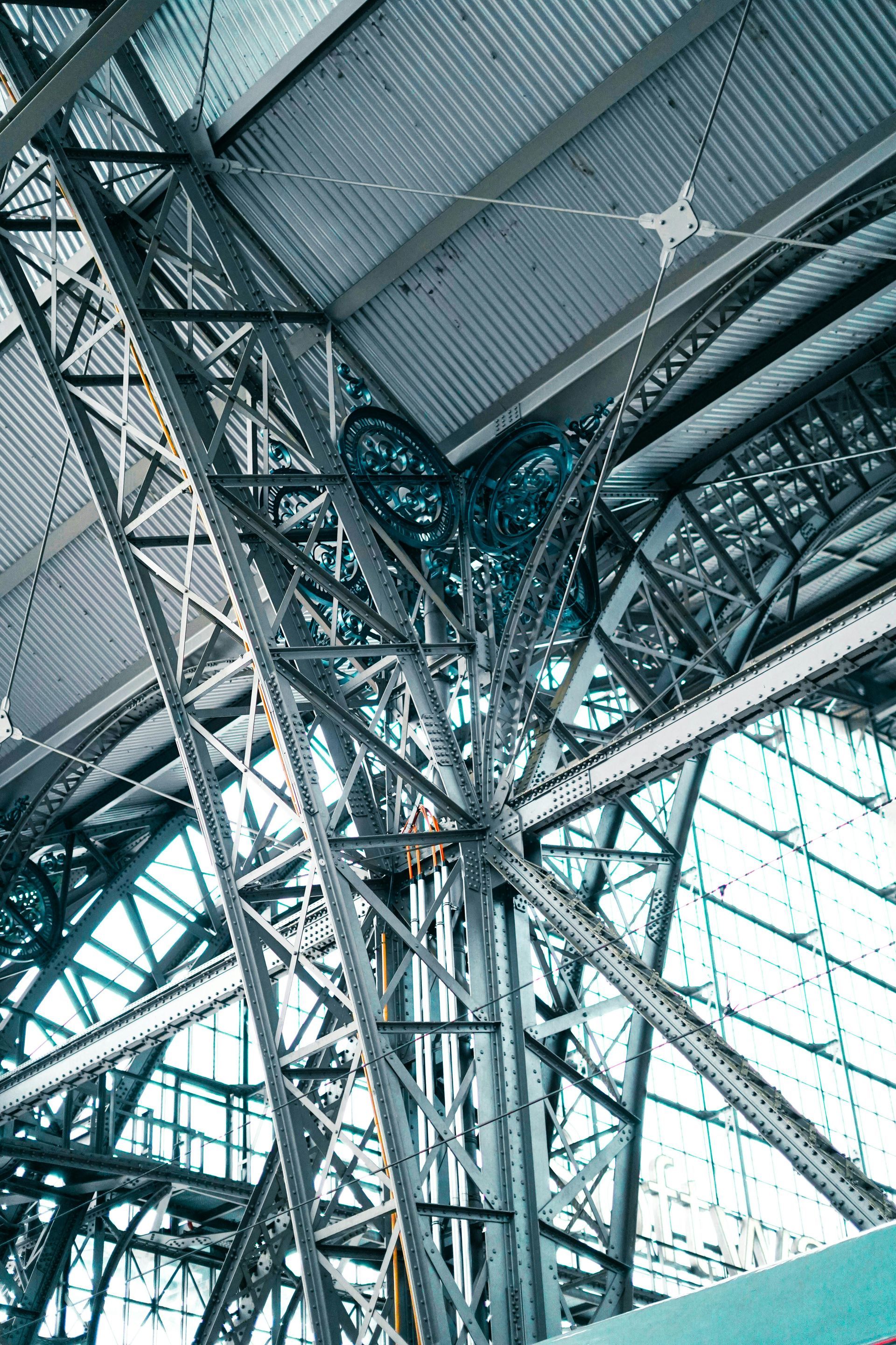 Steel structure inside a building with a glass roof.