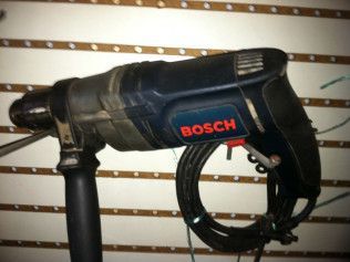 A bosch drill with a cord attached to it