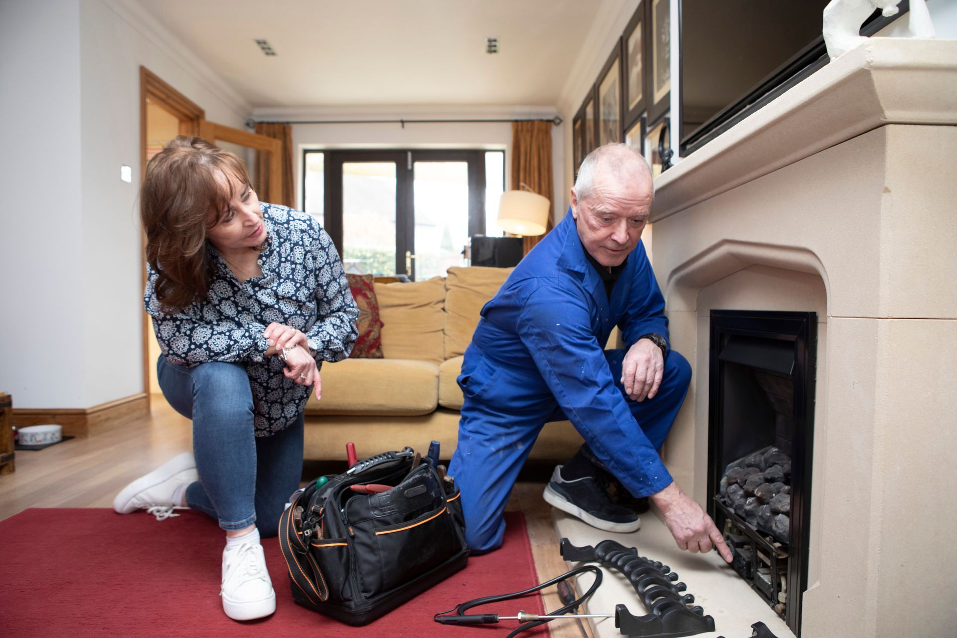Male roofer with a female client discussing professional chimney cleaning.