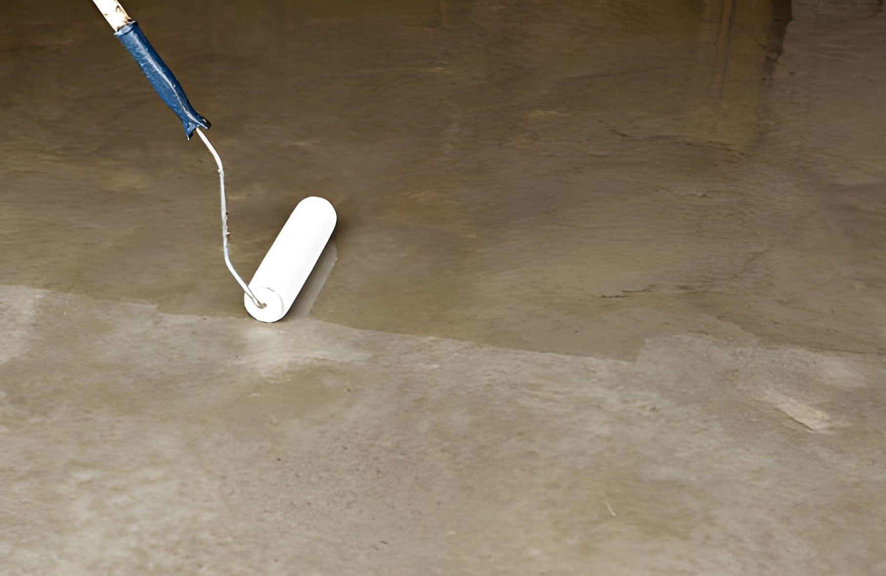 Two-story house with gray siding and garage in a suburban neighborhood at dusk, with wet road in front.