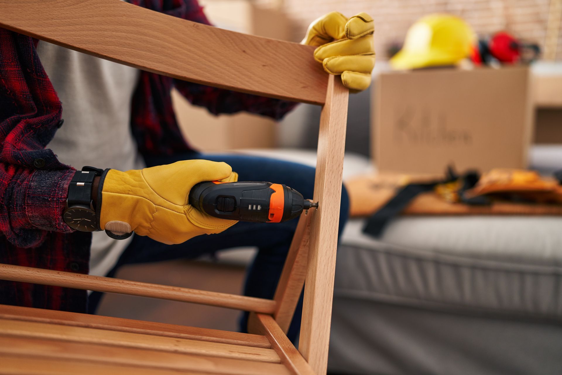 A person is using a drill to fix a piece of wood.