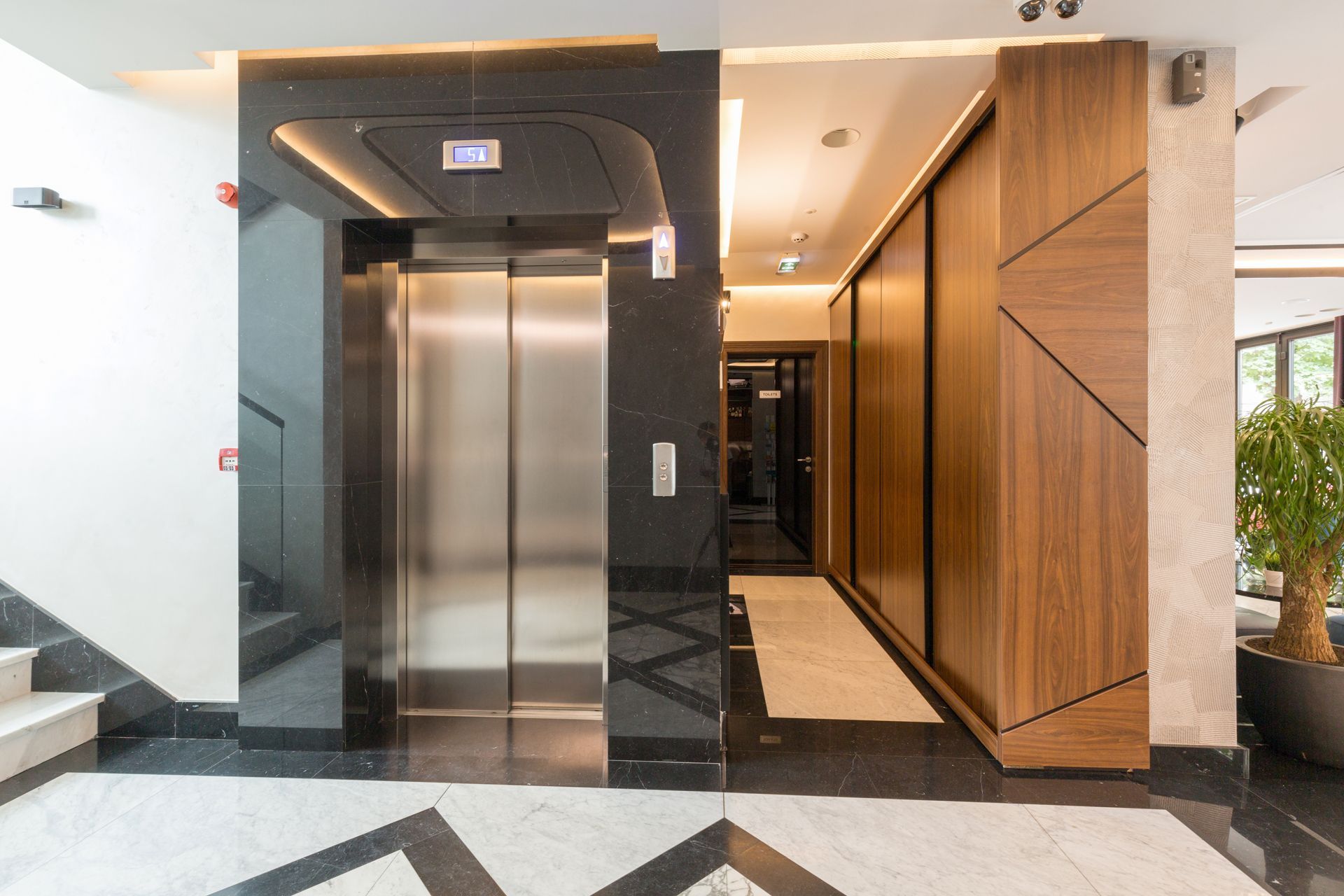 An Elevator is Sitting in the Middle of a Hallway in a Building